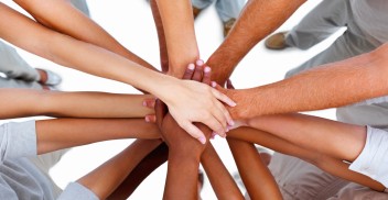 Business people standing with hands together